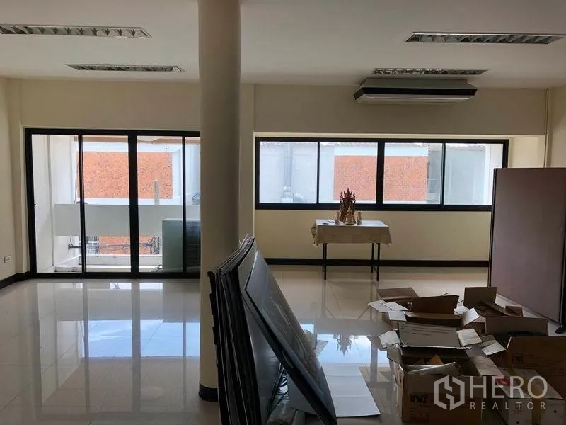 Home Office for rent in Khlong Toei, Bangkok - Large upper-floor open office with sliding doors to balcony and wide windows.