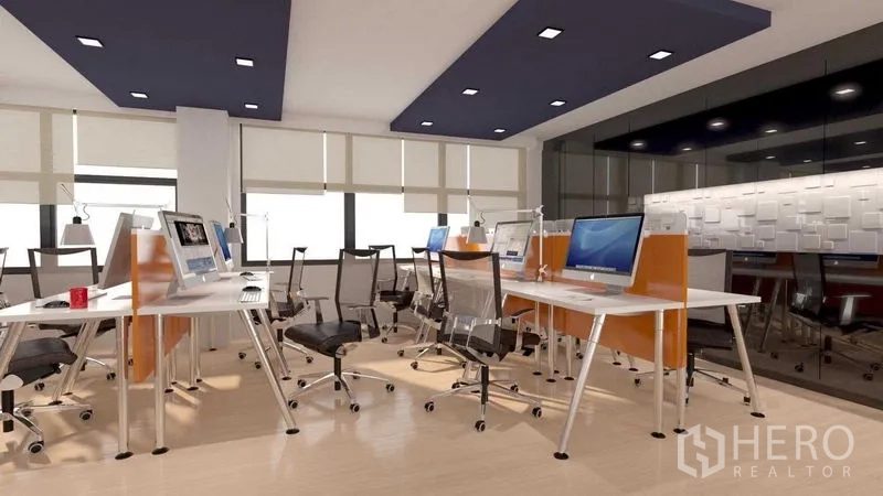 Shophouse for rent in Khlong San, Bangkok - Bright office floor with multiple workstations, ergonomic chairs and wide windows.