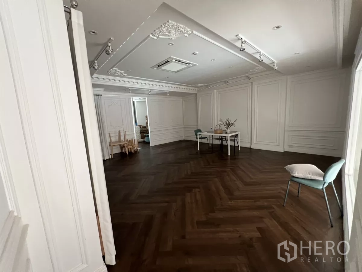 Retail Space for rent in Watthana, Bangkok - Spacious upper floor studio with dark herringbone wood floor and decorative molding.