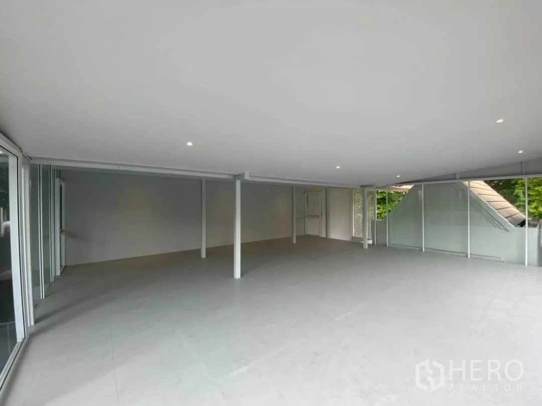 Home Office for rent in Watthana, Bangkok - Bright upper-floor office space with recessed lighting and wraparound glass windows.