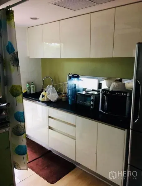 บ้าน ขายในPhra Khanong, Bangkok - ครัวบิวท์อินสมัยใหม่ ตู้สีขาวเงา เคาน์เตอร์หินสีดำ พร้อมเครื่องใช้ไฟฟ้า