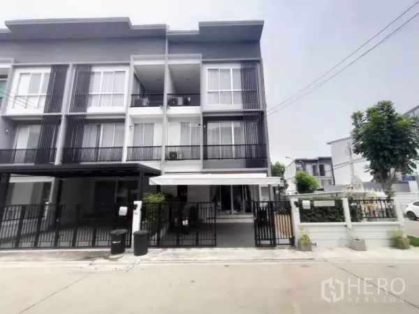 Home Office for rent or sale in Bang Khen, Bangkok - Modern three-storey home office exterior with gated parking and balconies.
