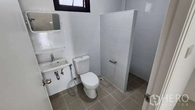 Factory for rent in Bang Bo, Samut Prakan - Second restroom with white tiles, toilet, sink and divider
