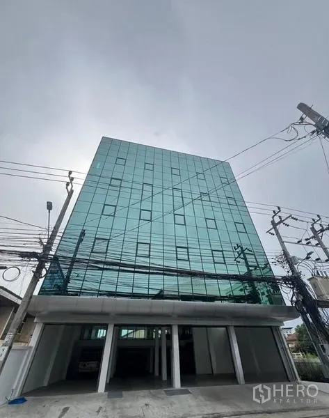Office Space for rent or sale in Wang Thonglang, Bangkok - Glass-clad office building exterior with parking access in Wang Thonglang.