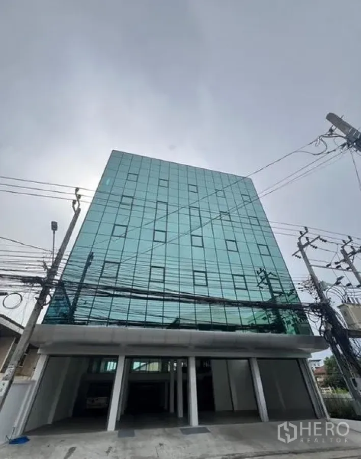 Office Space for rent or sale in Wang Thonglang, Bangkok - Glass-clad office building exterior with parking access in Wang Thonglang.