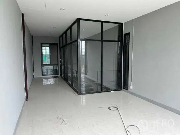 Warehouse for rent in Bang Phli, Samut Prakan - Second-floor office area with glass-partition meeting room and bright tiled flooring.