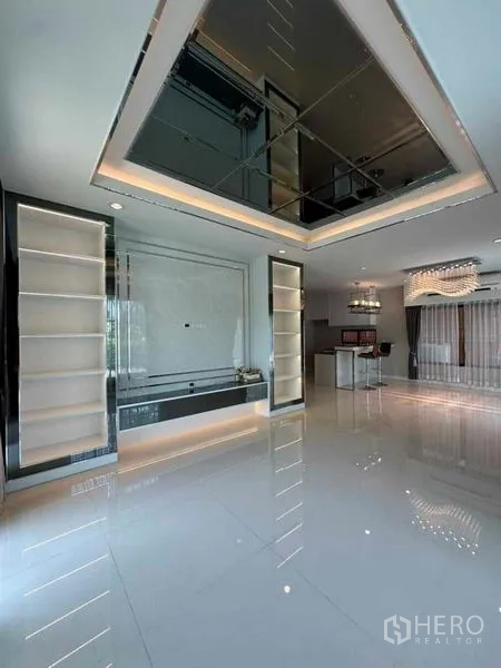 Detached House for sale in Prawet, Bangkok - Open-plan lounge showing feature ceiling, illuminated shelves and breakfast bar.