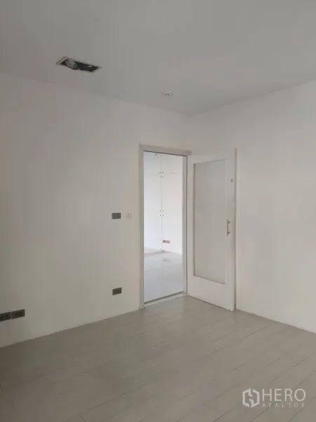 สำนักงาน ให้เช่าในKhlong Toei, Bangkok - ห้องสีขาวมินิมอล พื้นลายไม้ พร้อมประตูกระจกเชื่อมไปยังโซนสำนักงานปูกระเบื้อง