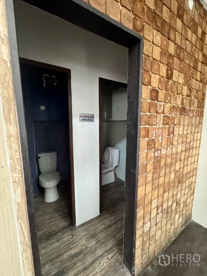 Shophouse for rent in Sathon, Bangkok - Two separate restrooms with tiled finishes and standard fixtures.