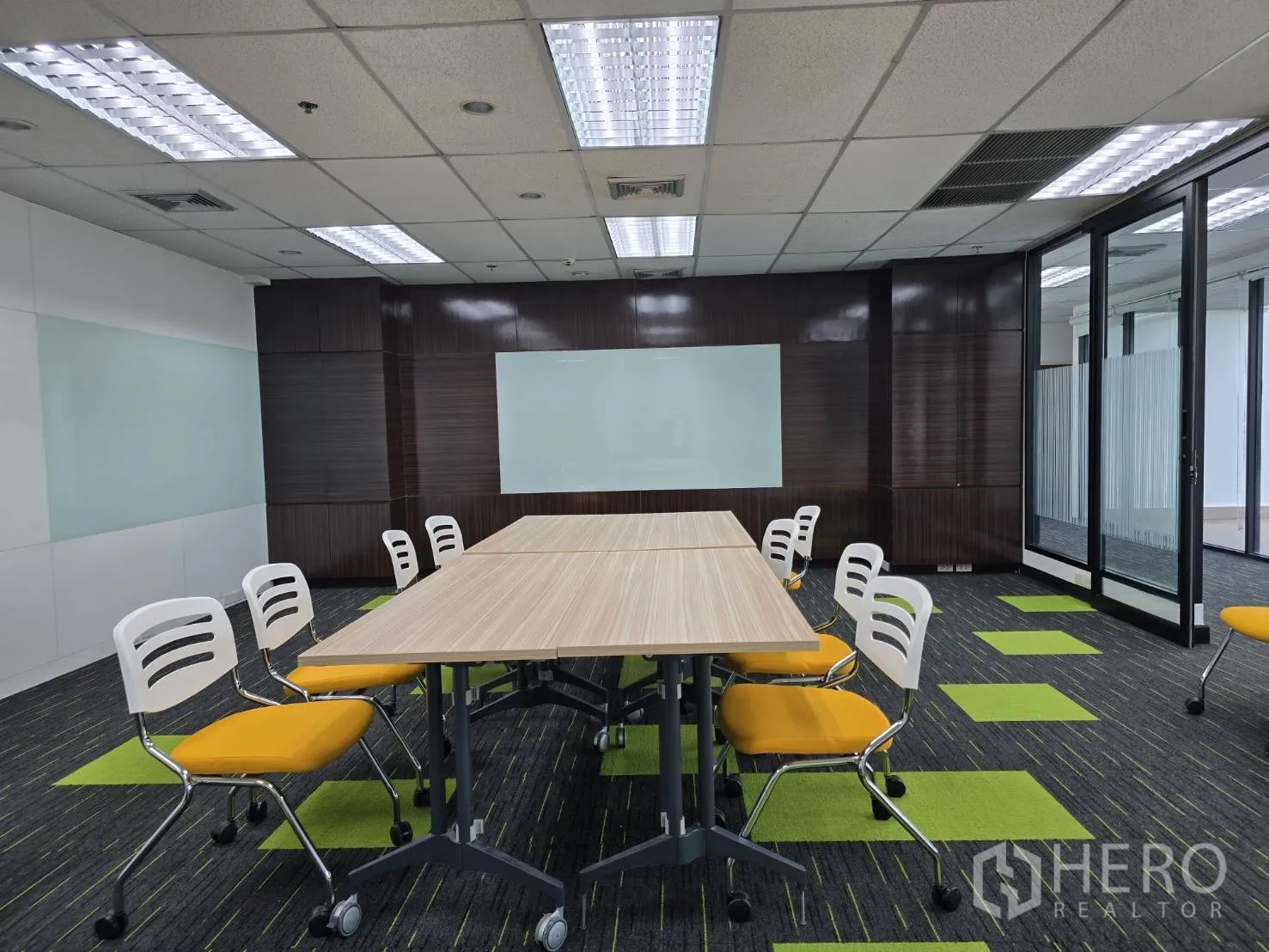Office Space for rent in Watthana, Bangkok - Modern conference room with wood wall panels and dual whiteboards.