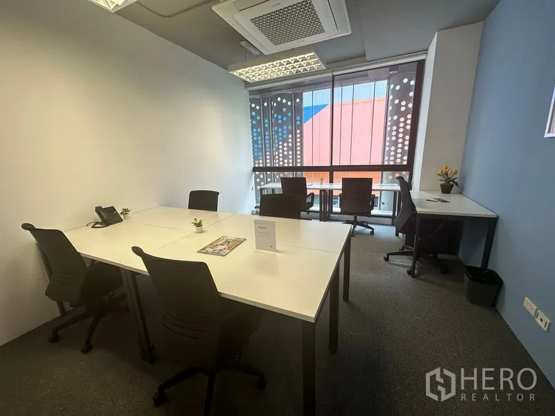 Office Space for rent - Bright office room featuring multiple workstations, ergonomic chairs, LED ceiling lights and full-height glazed window.