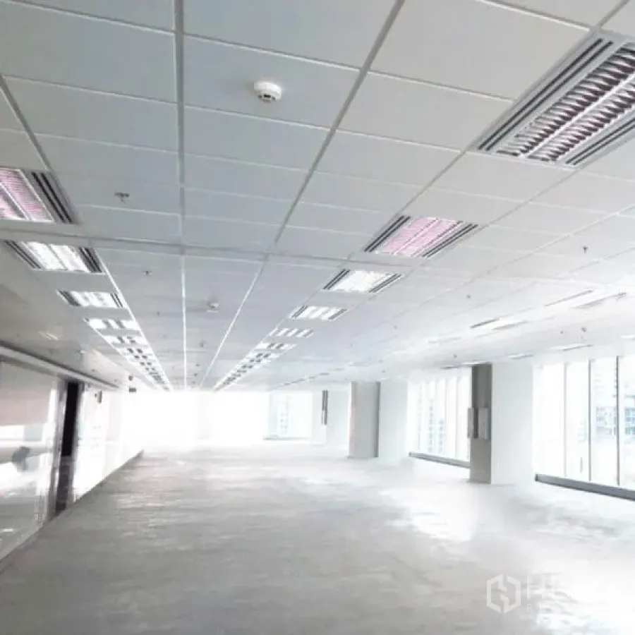 Office Space for rent in Khlong Toei, Bangkok - Unfurnished office floor plate with suspended ceiling lights and a wide window line.