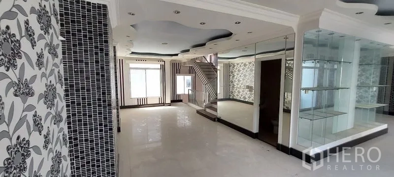 Home Office for sale in Wang Thonglang, Bangkok - Upper-floor open space with patterned wallpaper, glass display and mirrors.