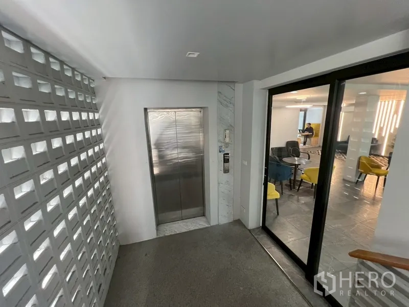 带办公室的家 出租或出售在Phra Khanong, Bangkok - 电梯大堂，旁边为通往休息区的玻璃门