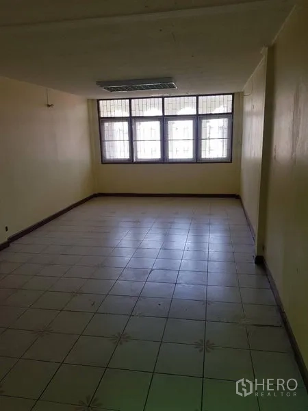 พื้นที่ขายปลีก ให้เช่าในKhlong Toei, Bangkok - ห้องกว้างปูพื้นกระเบื้อง มีหน้าต่างบานใหญ่ติดเหล็กดัดและไฟเพดาน