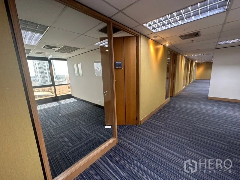 Office Space for rent in Khlong Toei, Bangkok - Hallway with wood-trim glass partitions leading to private offices.