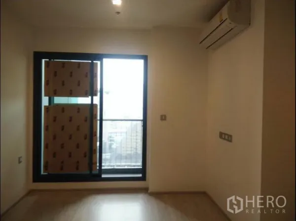 公寓 出售在Ratchathewi, Bangkok - 卧室配壁挂空调与通往阳台的推拉玻璃门