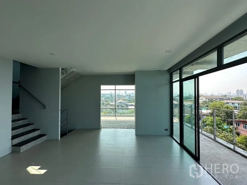Home Office for rent or sale in Prawet, Bangkok - Open-plan upper floor with big windows and access to a wraparound terrace.