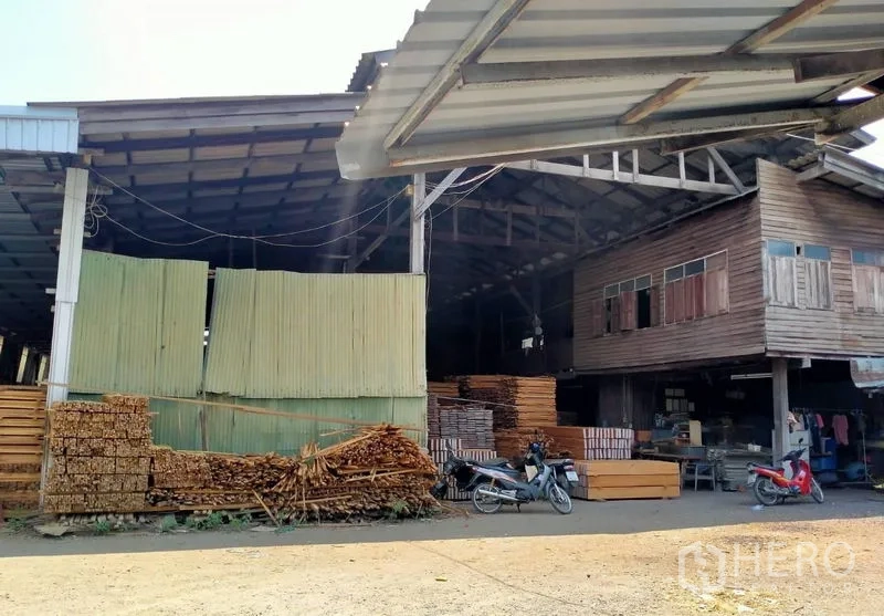 Warehouse for sale in Mueang Nonthaburi, Nonthaburi - Wide-span shed exterior with corrugated panels and attached wooden office section.