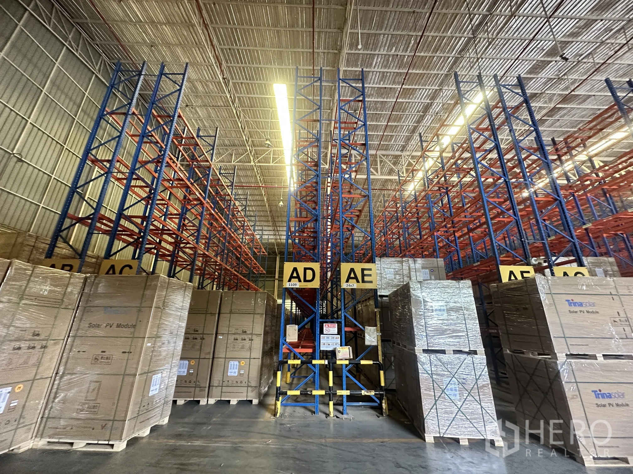 Warehouse for rent in Lat Krabang, Bangkok - Storage bays labeled AD and AE with pallet racks and concrete floor.