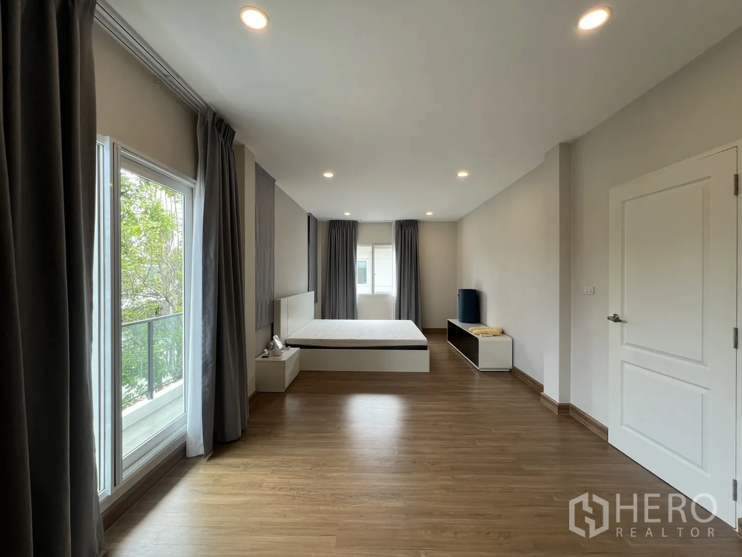 Detached House for rent in Lat Krabang, Bangkok - Master bedroom view toward the balcony with greenery outside.