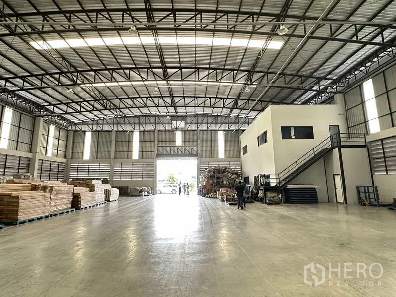 货栈 出租在Bang Phli, Samut Prakan - 明亮的仓库内部，面向卷帘门入口，空间宽广并配有办公室盒体。