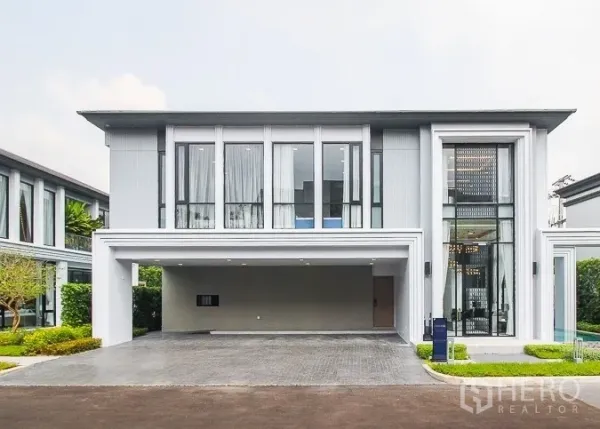Detached House for rent or sale in Prawet, Bangkok - Contemporary two-storey house exterior with wide garage and tall windows.