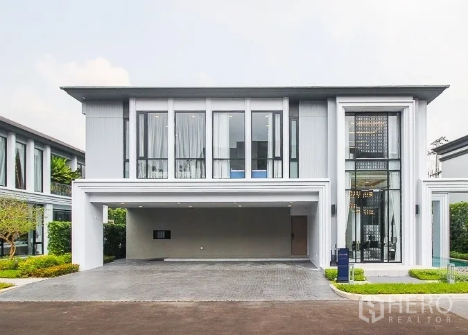 Detached House for rent or sale in Prawet, Bangkok - Contemporary two-storey house exterior with wide garage and tall windows.