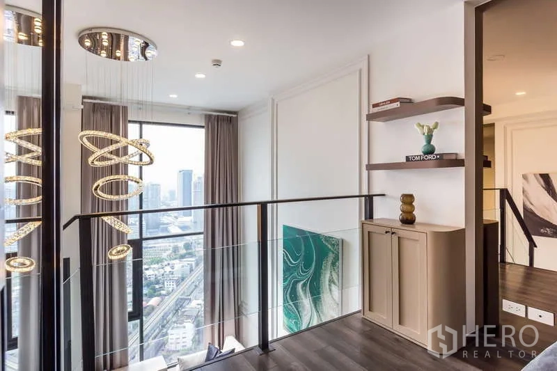 Condominium for rent or sale - Upper landing with designer ring chandelier, shelves and city-facing windows.