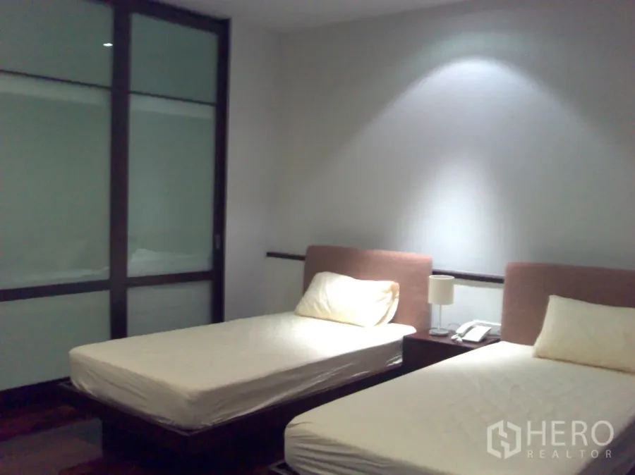 คอนโด ให้เช่าในWatthana, Bangkok - ห้องนอนเตียงเดี่ยวคู่ แสงไฟนุ่มนวล พื้นไม้ และตู้เสื้อผ้าบานเลื่อนกระจกฝ้า