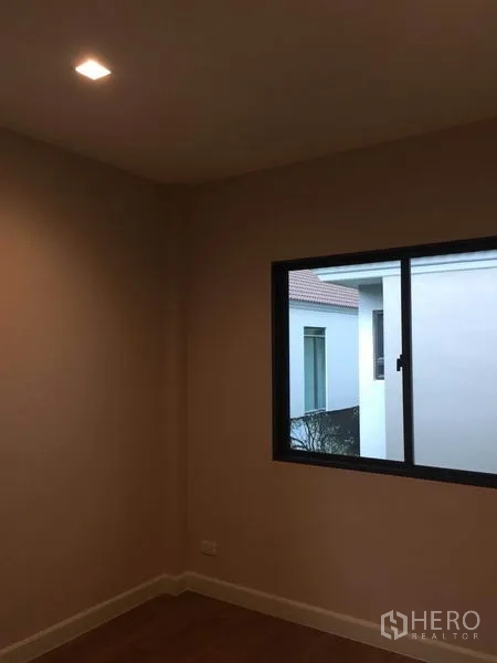 Detached House for sale in Pak Kret, Nonthaburi - Cozy bedroom corner with window and timber flooring