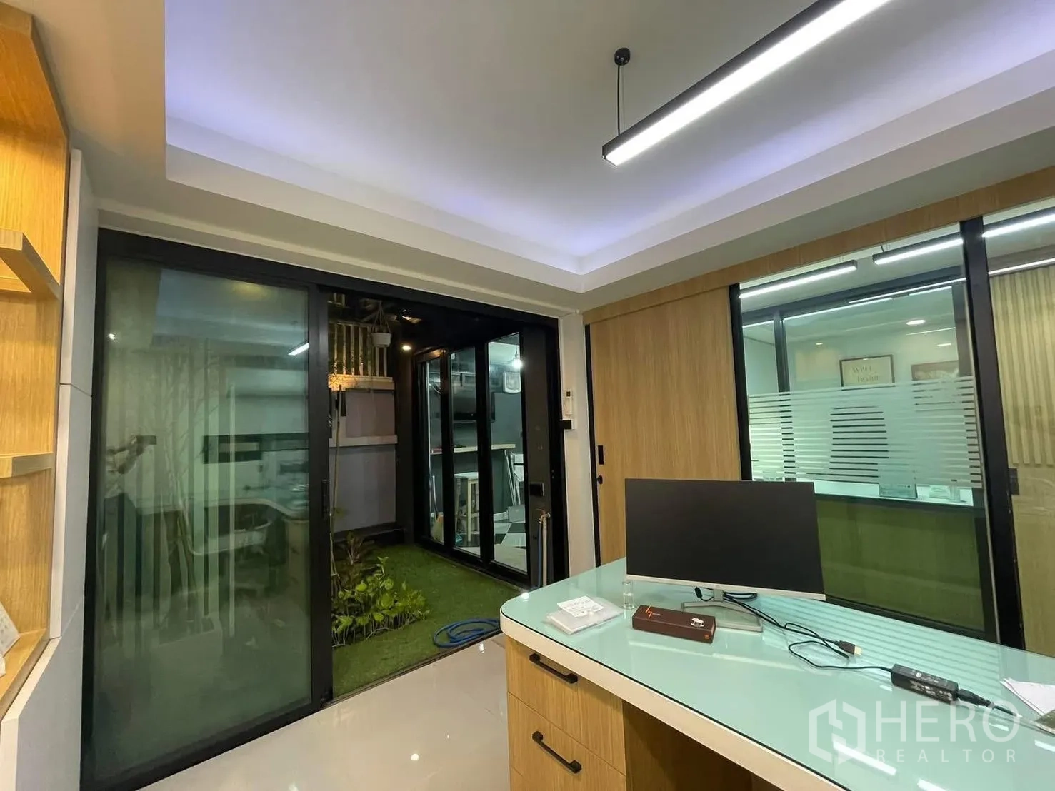 Home Office for rent or sale in Bang Kapi, Bangkok - Private office opening to a small grassed patio through sliding glass doors.
