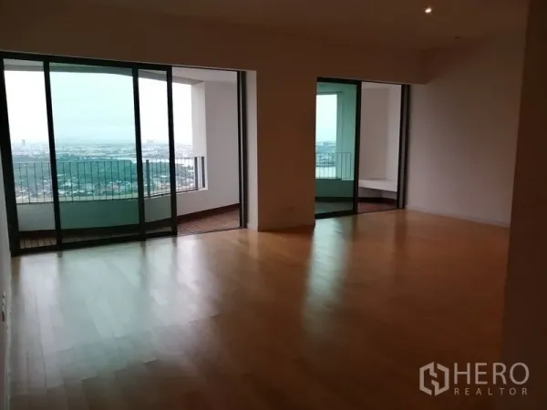 Condominium for sale in Yan Nawa, Bangkok - Spacious living area with floor-to-ceiling sliding doors opening to two covered balconies.