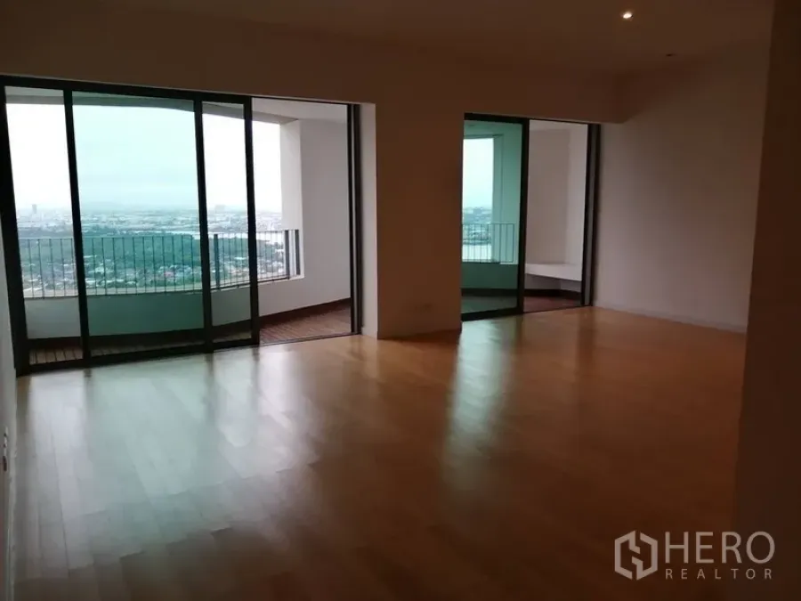 Condominium for sale in Yan Nawa, Bangkok - Spacious living area with floor-to-ceiling sliding doors opening to two covered balconies.
