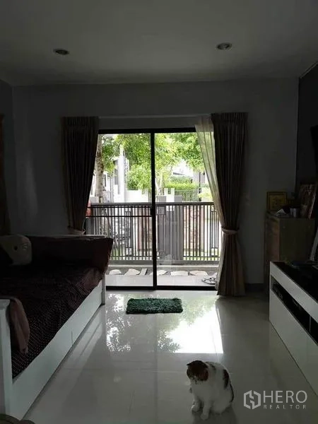 Detached House for sale in Bang Phli, Samut Prakan - Bedroom with sliding glass door opening to a small balcony or patio with garden view