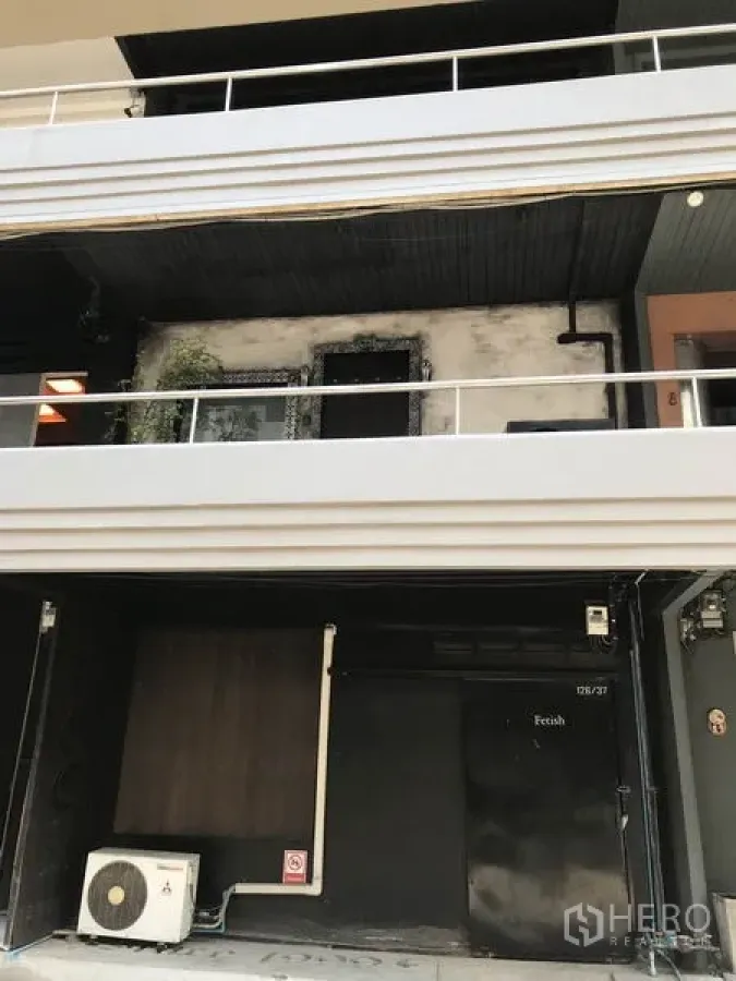 Office Space for rent in Watthana, Bangkok - Low-rise commercial building facade in Ekkamai, Watthana, with balcony railings, signage-ready shopfront and exterior air-conditioning unit.