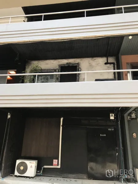 Office Space for rent in Watthana, Bangkok - Low-rise commercial building facade in Ekkamai, Watthana, with balcony railings, signage-ready shopfront and exterior air-conditioning unit.