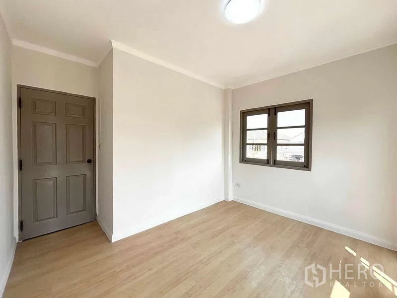 Detached House for rent or sale - Bright bedroom with wood floors, grey door and double casement window.