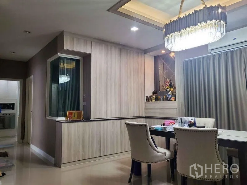 Detached House for sale in Bueng Kum, Bangkok - Dining area with crystal chandelier, built-in storage and air conditioning.