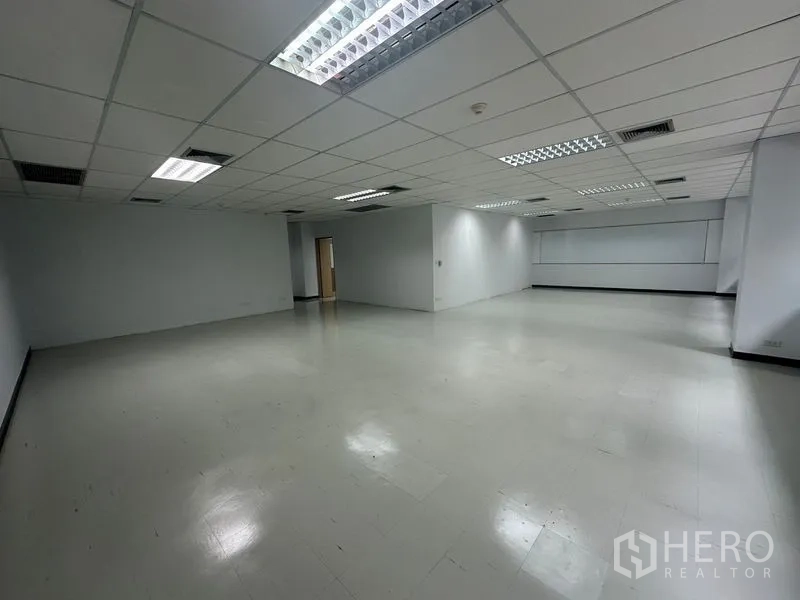 Office Space for rent in Bang Rak, Bangkok - Large empty workspace featuring a suspended ceiling, multiple light fixtures, and AC vents.