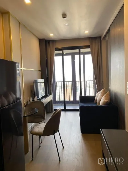 Condominium for rent in Watthana, Bangkok - Galley living space from kitchen to balcony with dining set and sofa.