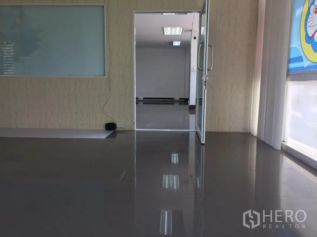Home Office for rent or sale in Bang Khun Thian, Bangkok - Glass door opening to a glossy tiled office space filled with natural light.