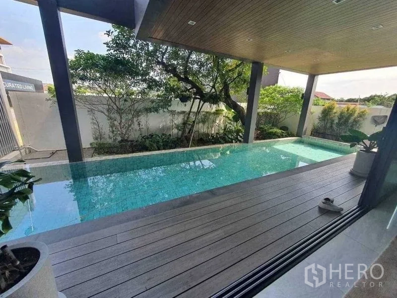 Detached House for rent or sale in Prawet, Bangkok - Covered lap pool with wood ceiling and poolside deck.