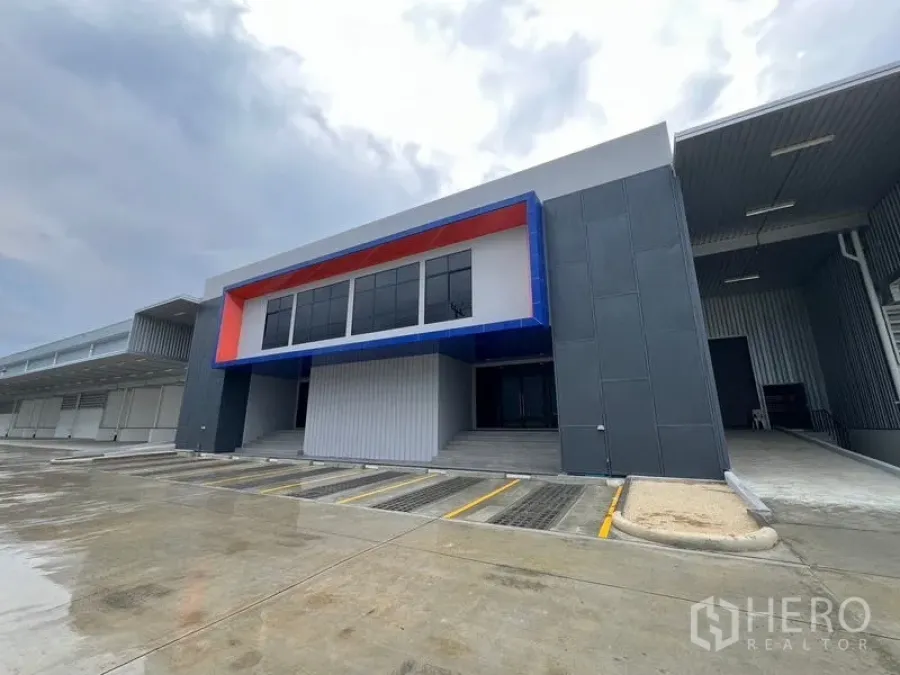 Warehouse for rent in Chon Buri - Contemporary warehouse frontage with wide driveway, canopy and truck access.