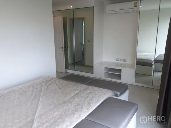 คอนโด ให้เช่าในKhlong Toei, Bangkok - ห้องนอนหลักพร้อมตู้เสื้อผ้าบานกระจก เตียงขนาดใหญ่ และเครื่องปรับอากาศ