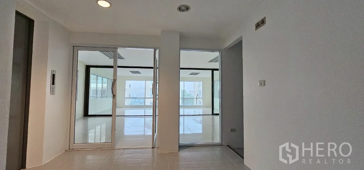 Office Space for rent in Bueng Kum, Bangkok - Lift lobby with two glass doorways leading into separate office suites.