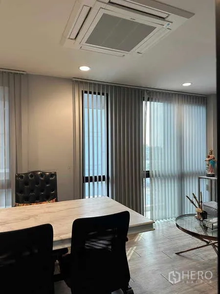 Home Office for rent in Bueng Kum, Bangkok - Private manager’s office with large table, high-back chair, and tall windows with blinds.