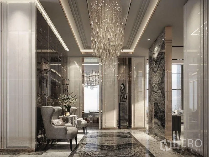 Condominium for sale in Bangkok - Elegant foyer with statement chandelier, marble floors and glossy wall panels.