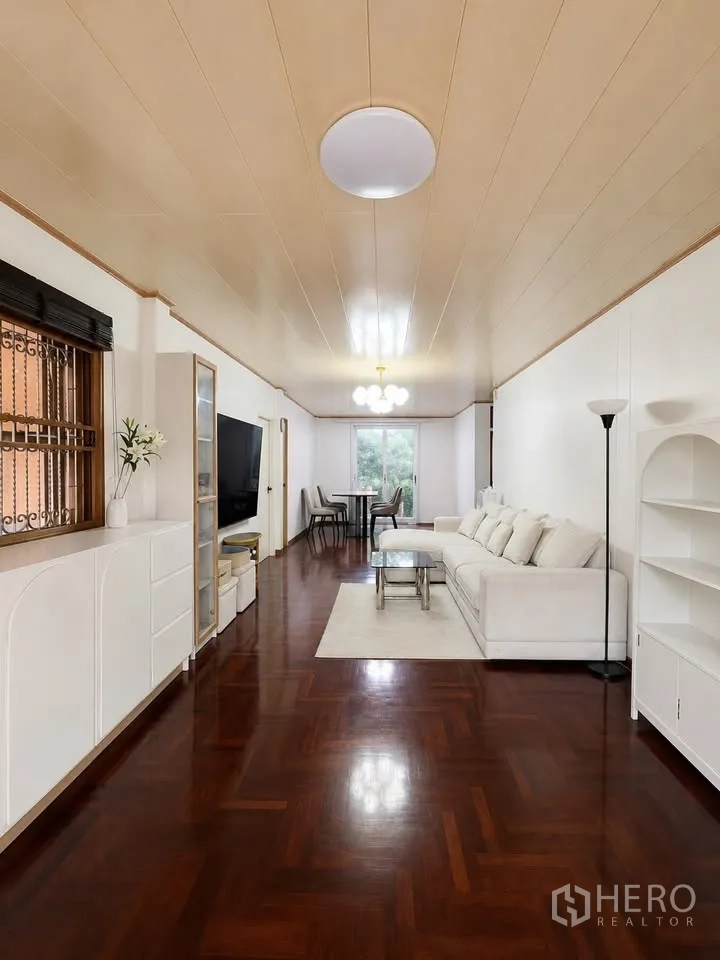 Detached House for rent in Prawet, Bangkok - Open-plan living and dining area with white cabinetry and sofa.