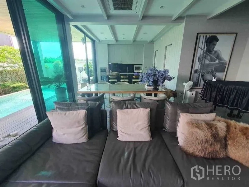 Detached House for rent or sale in Prawet, Bangkok - Open-plan living and kitchen facing the pool through sliding glass doors.